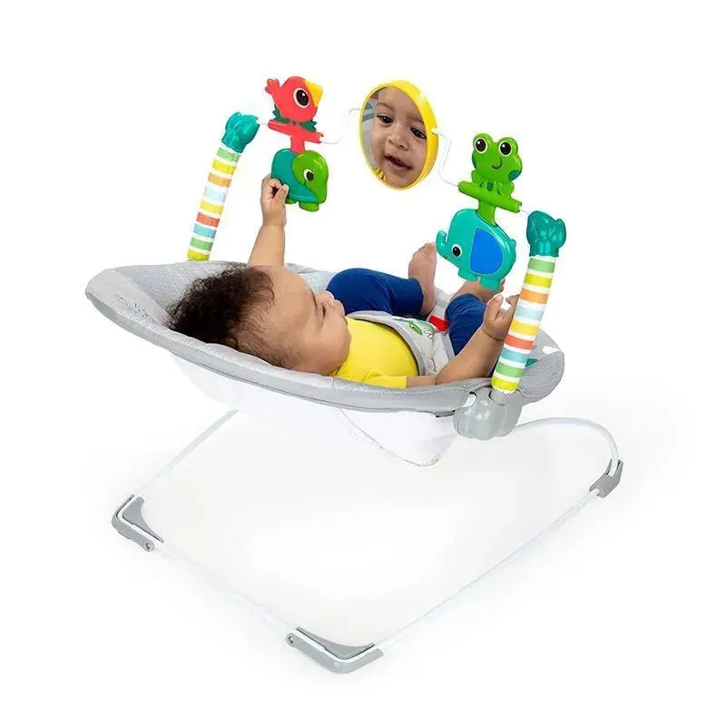 Comfy baby bouncer seat with soothing vibration, featuring colorful toys and a mirror, with an infant comfortably playing.
