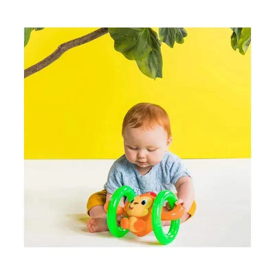 Crawling baby playing with the Kids II Bright Starts Roll & Glow Monkey toy, featuring vibrant colors and wheels.