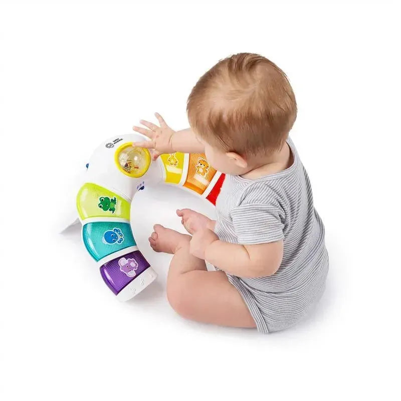 Toddler interacts with the Kids II Glow & Discover Light Bar Activity Station, a colorful toy featuring lights and animal designs.
