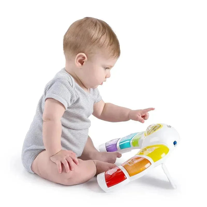 Baby exploring the Kids II Glow & Discover Light Bar Activity Station with colorful buttons and interactive features.
