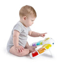Baby exploring the Kids II Glow & Discover Light Bar Activity Station with colorful buttons and interactive features.
