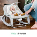 Vibrating baby bouncer with a surprised baby, featuring an overhead toy and a hand adjusting the bouncer mode.