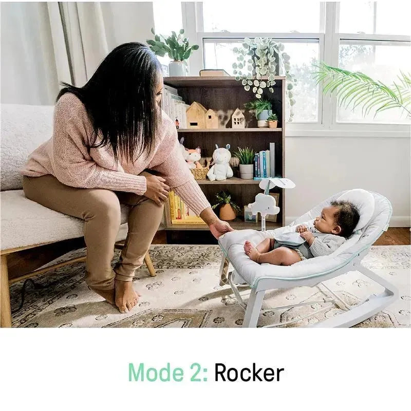 Vibrating baby bouncer in rocker mode; a mother adjusts the seat while her baby relaxes inside.