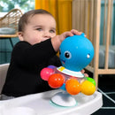 Baby interacting with the colorful Kids II Opus’s Spin & Sea Activity Toy featuring an octopus design and textured balls.