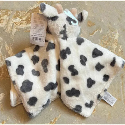 Soft plush cow lovey with gray spots, secure clasp, and tag; designed for infants as a snuggler or security blanket.
