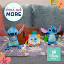 Disney Baby Lilo and Stitch plush toys with an ukulele and colorful activity book on a patterned blanket.