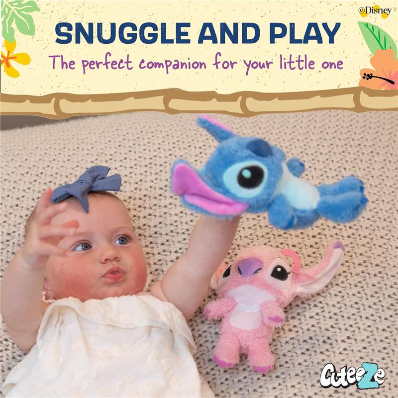 Baby reaching for a blue Stitch plush toy while a pink Angel plush toy sits nearby on a light, textured surface.