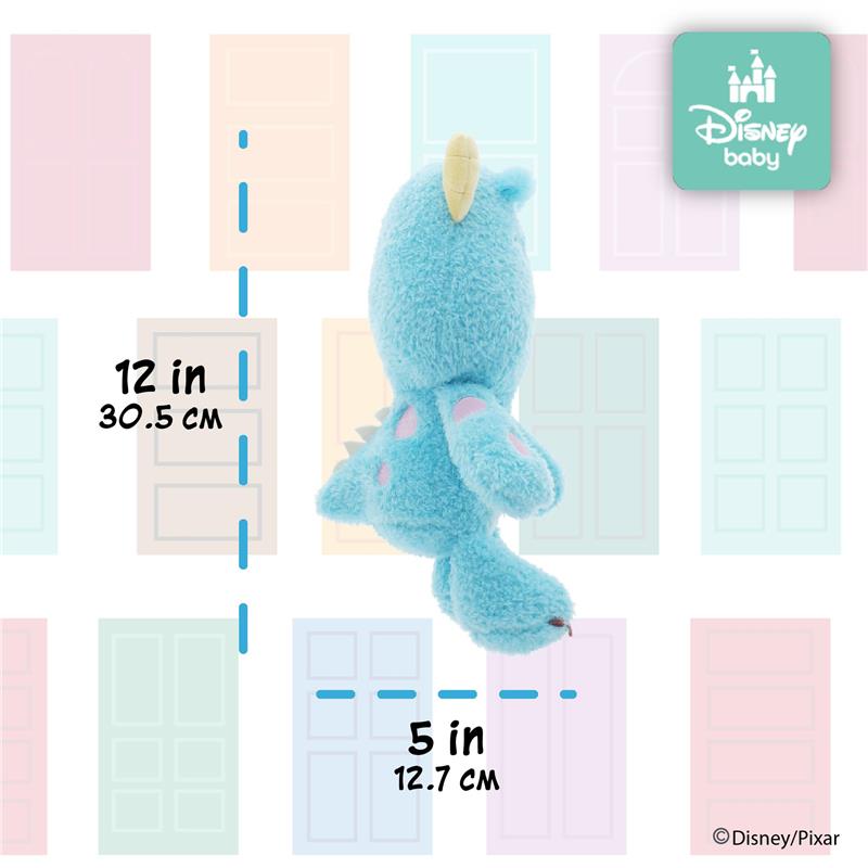 Plush stuffed animal of Sully from Monsters Inc., measuring 12 inches tall and 5 inches wide, against a pastel door backdrop.