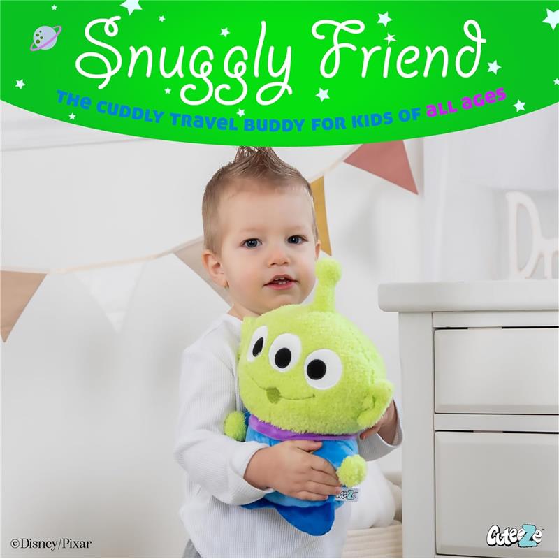 Child holds a plush Little Green Man alien from Toy Story, smiling in a bright room with decorative bunting in the background.