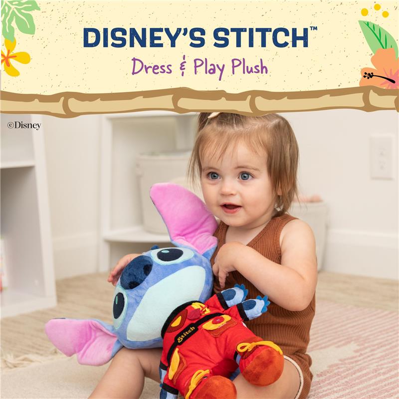 Toddler holding a plush Disney Stitch toy, dressed in a colorful costume, smiling while sitting on a soft rug.