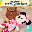 Disney Minnie Mouse plush toy dressed in a polka dot outfit, being held by a baby, with decorative text promoting Disney characters.