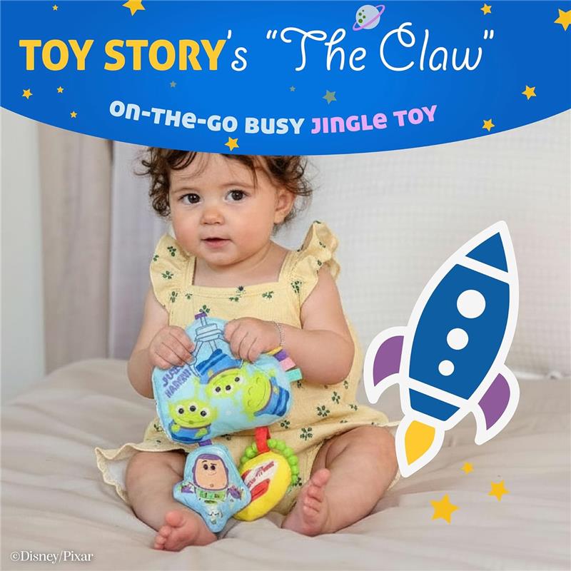 Toddler sitting on a bed, holding the Disney Toy Story Jingle Toy featuring Little Green Aliens and Buzz Lightyear.