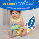 Toddler sitting on a bed, holding the Disney Toy Story Jingle Toy featuring Little Green Aliens and Buzz Lightyear.