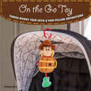 Disney Toy Story Woody in a Barrel activity toy hangs from a stroller with a smiling Woody figure and a green dinosaur.