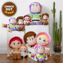 Toy Story plush dolls featuring Woody, Buzz Lightyear, Jessie, and others, arranged on display near a tall cactus.