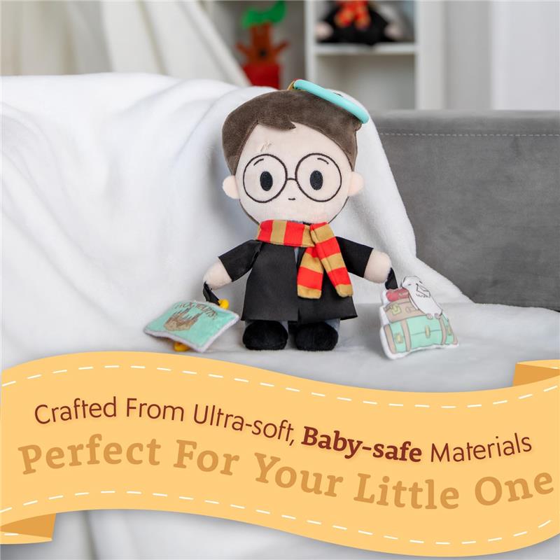 Harry Potter plush toy dressed in a black robe and red-striped scarf, holding a book and two colorful bags.