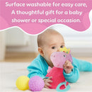 Soft Peppa Pig activity toy with fairy wings, surrounded by colorful balls, held by a smiling baby.