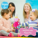 Peppa Pig activity toy held by a toddler during playtime, with two children and adults in the background.
