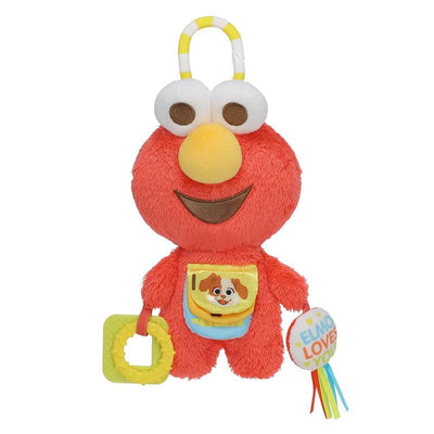 Elmo plush toy holding a teething ring and a colorful round toy; features include a smiling face and a pocket with a dog design.