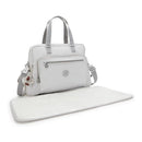 Kipling Alanna Baby Bag in Cool Fog with a front zip pocket and detachable shoulder strap, accompanied by a changing mat.