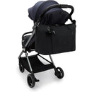 Kipling Art Baby Diaper Bag in Black Noir attached to a stroller, featuring a front zip pocket and charm.