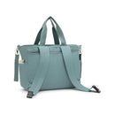 Convertible diaper backpack in tiny green color with adjustable straps and top carry handles.
