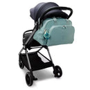 Kipling Camama Diaper Bag in Tiny Green Air attached to a stroller, featuring a blue keychain accessory.