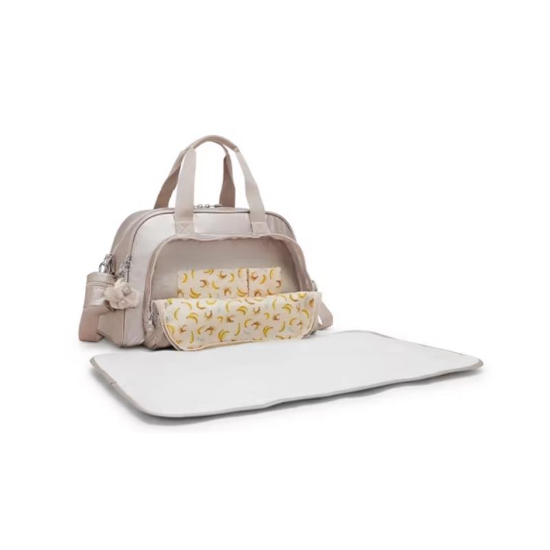 Kipling Camama Diaper Bag in Tiny Metallic Glow, featuring a cream exterior, organized interior, and a changing mat.