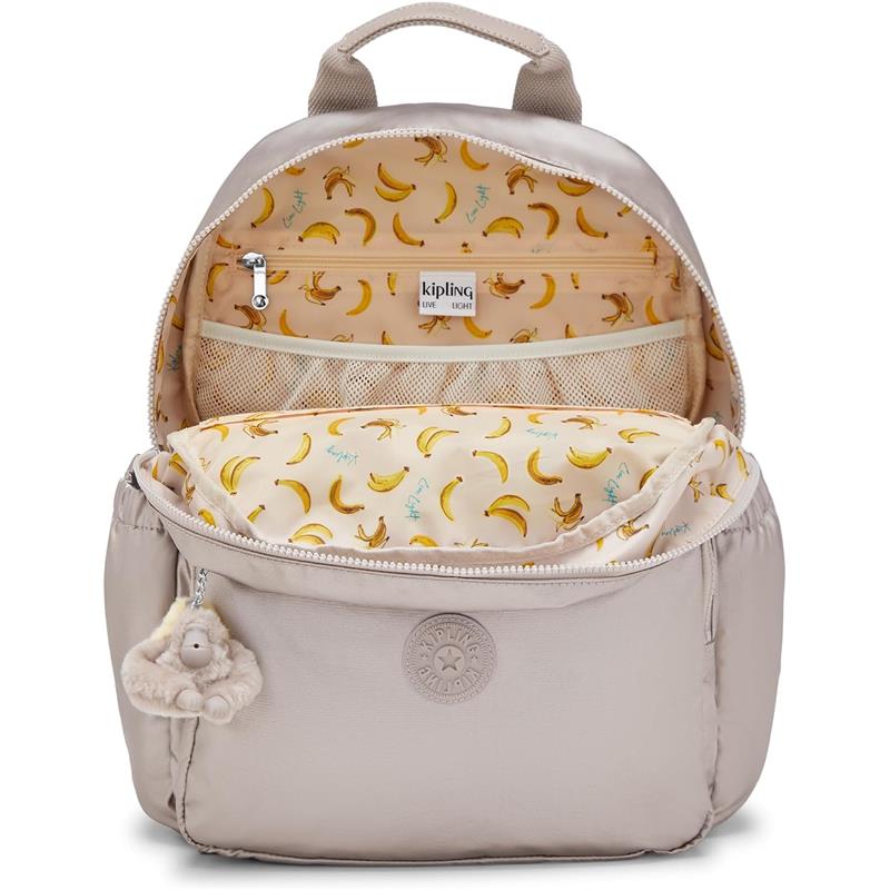 Kipling Maisie Diaper Backpack in Tiny Metallic Glow with banana-patterned lining and a fluffy monkey keychain attached.