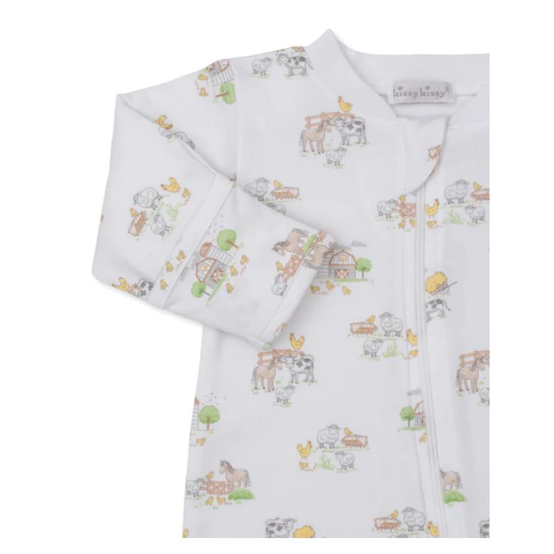 Kissy Kissy Fun On the Farm zip footie featuring a farm animal print, including cows, horses, and chickens, on a white background.