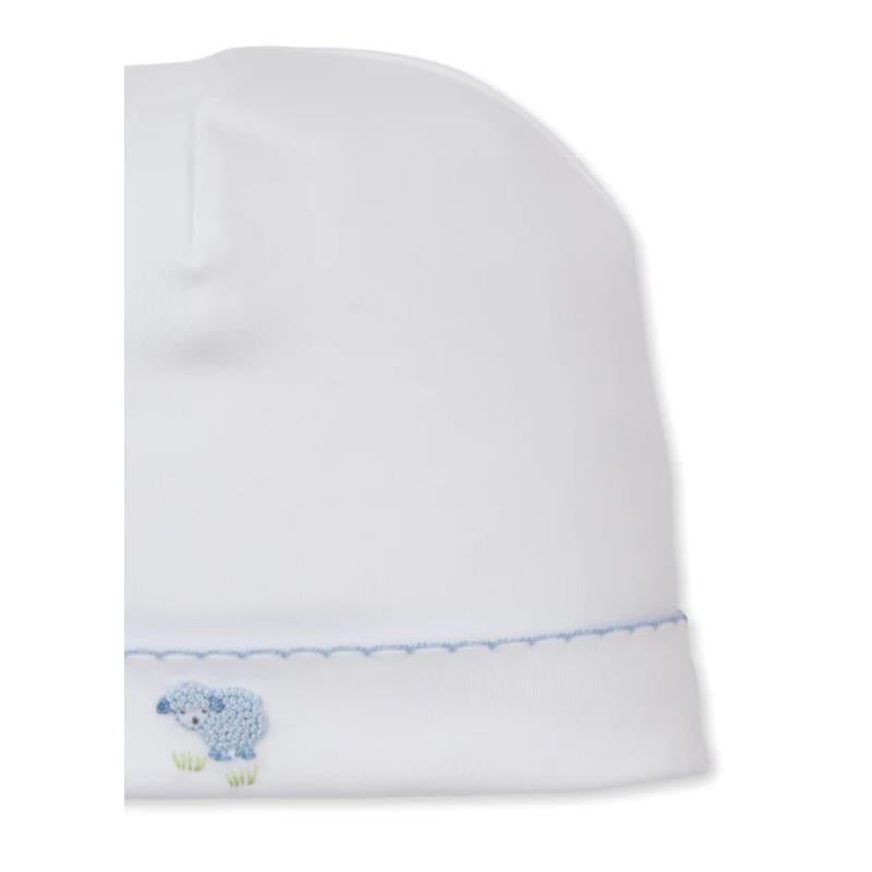 White baby hat featuring hand embroidery of a blue sheep at the base, with a delicate blue stitched trim.