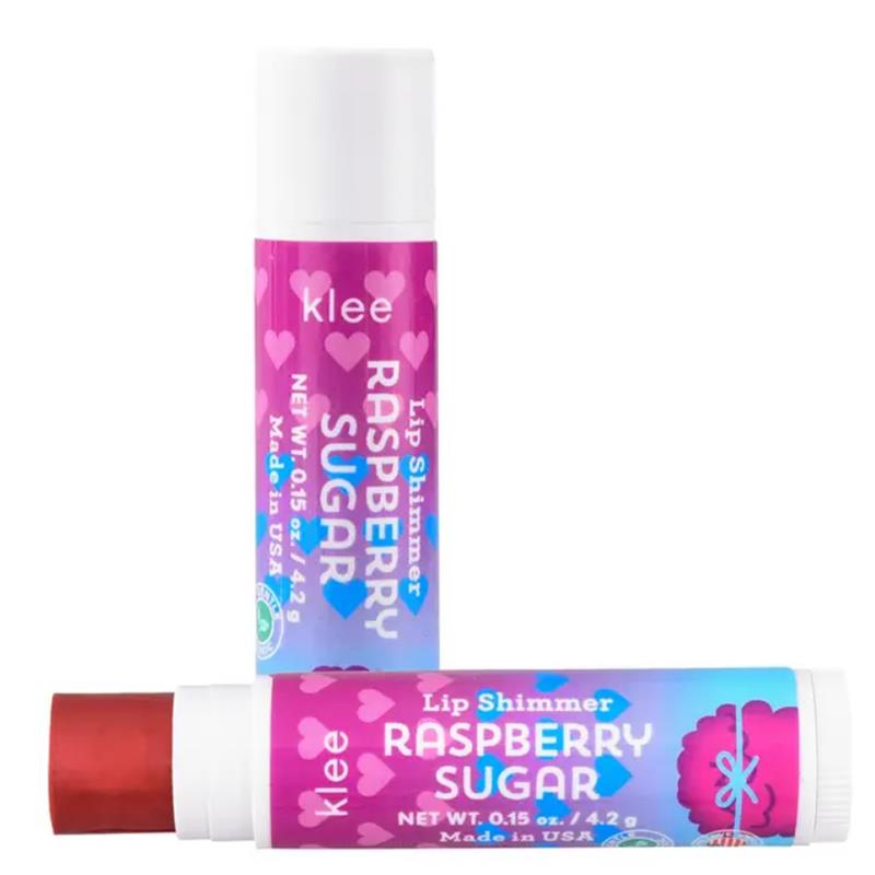 Klee Naturals Raspberry Sugar Lip Shimmer set featuring two tubes, one with a pink label and hearts, the other with a blue label.