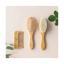 Bamboo brush and comb set by Kyte Baby, featuring a wide-tooth comb and two brushes with soft bristles.