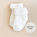 White baby socks with fold-over cuffs, featuring a soft terry lining and a subtle logo, presented on a neutral background.