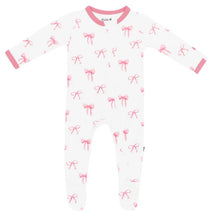 Baby girl zippered footie in white with pink bows, featuring long sleeves and pink trim.