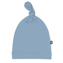 Bamboo baby knotted cap in slate blue, featuring a tied top and a small brand label on the side.