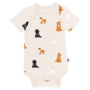 Baby neutral bodysuit featuring a playful print of various fluffy dog illustrations in different colors.