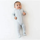 Neutral gray zippered footie for babies, displayed on an infant who is smiling and posing on a light background.