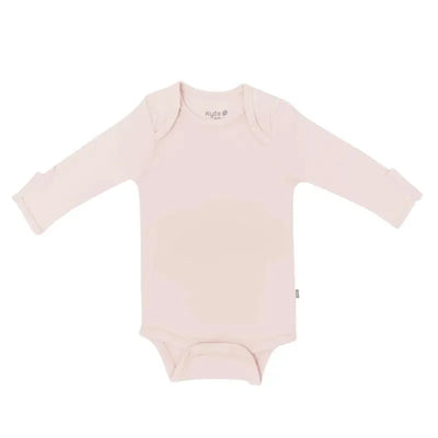 Long sleeve bodysuit in blush from Kyte Baby, featuring soft fabric and snap closures at the bottom.