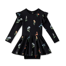 Long sleeve twirl bodysuit dress in black featuring colorful wildflower patterns and ruffled sleeves.