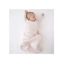 Bamboo sleep bag in blush color surrounds a peacefully sleeping baby with arms raised, against a white background.