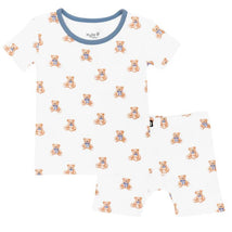 Short sleeve pajamas for kids featuring a teddy bear print, made from soft fabric with a blue trim.