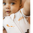 Infant wearing Kyte Baby Zipper Shortall Romper featuring colorful dachshund prints, with a cheerful expression.