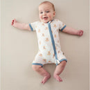 Short-sleeved zippered romper featuring a teddy bear print, worn by a smiling baby lying on a neutral background.