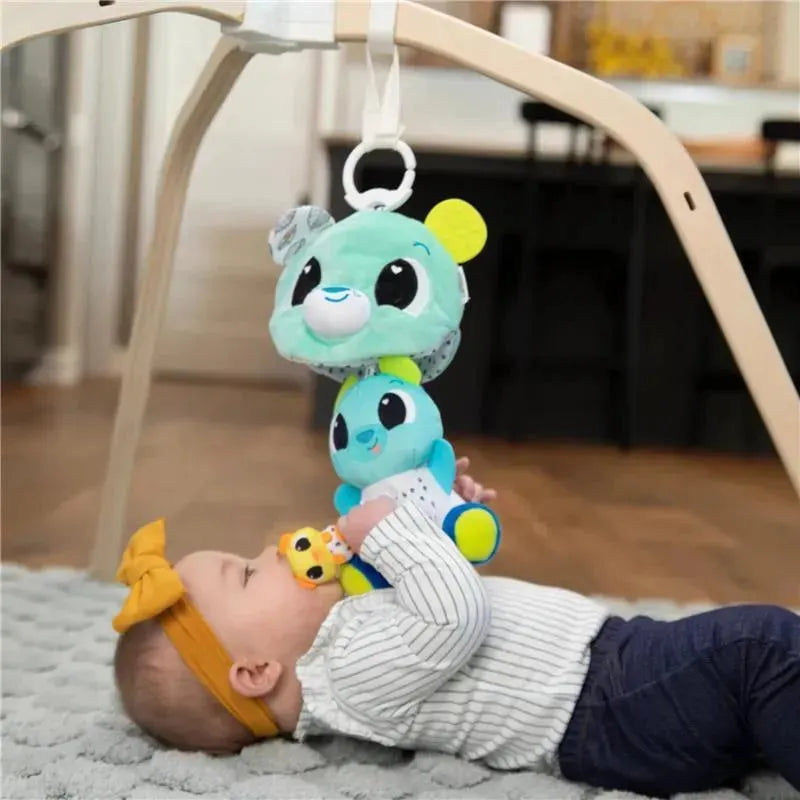 Baby plays with the Lamaze 3-In-1 Surprise Bear stroller toy, designed with colorful plush bears and a clip for attachment.