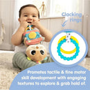 Smiling baby holds colorful Lamaze toy with clacking rings, promoting tactile and fine motor skill development.