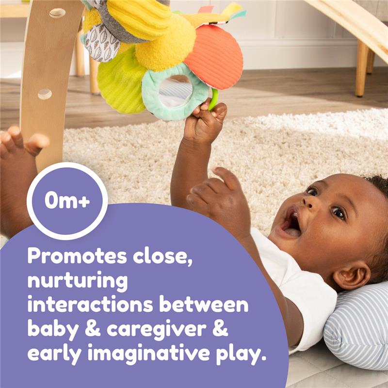 Lamaze Buzzy The Bee Clip & Go toy, featuring colorful fabric textures, promotes nurturing play between baby and caregiver.