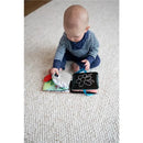 Baby exploring the Lamaze Colorful Journey Caterpillar™ Book, a sensory fabric toy with vibrant pages and textures.