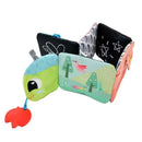 Colorful fabric book with a caterpillar design, featuring sensory elements and illustrations of animals and nature.