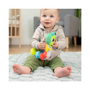 A happy baby sits on a soft rug, holding the vibrant Lamaze Fidget Fun Caterpillar toy featuring colorful segments and textures.